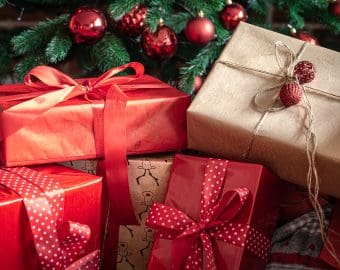 Close up of red gift boxes near the Christmas tree.