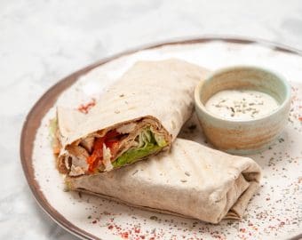 Top view lavash wraps yogurt small bowl plate stained white surface