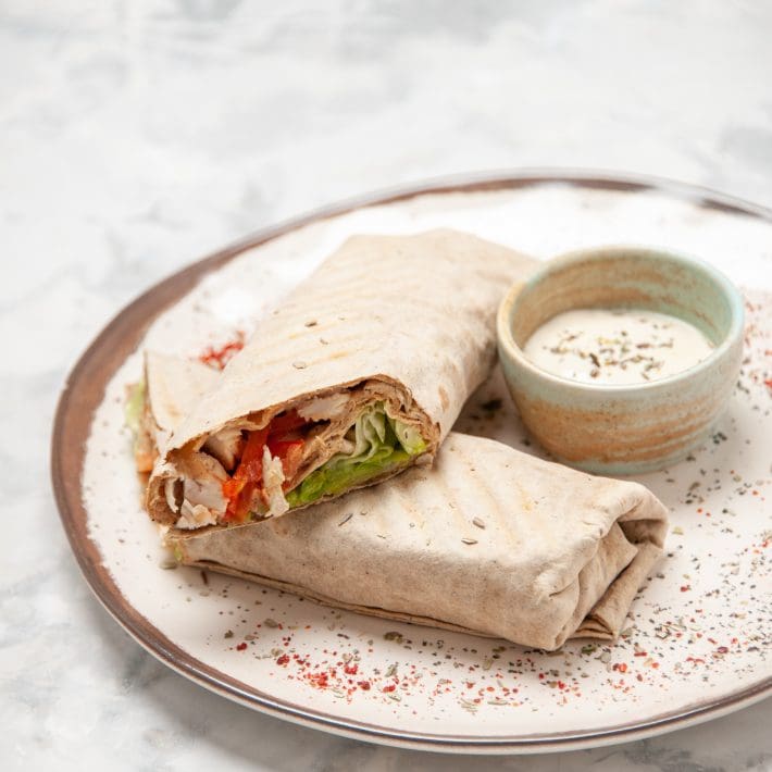 Top view lavash wraps yogurt small bowl plate stained white surface