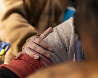 Young adult trying to wake up african american girl in the university library