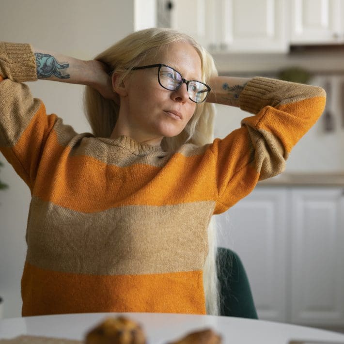 Albino woman home doing chores